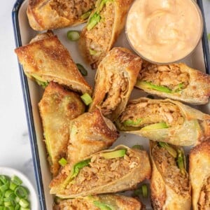 Seafood Egg Roll Recipe air fried and served cut in half on a tray with dipping sauce.