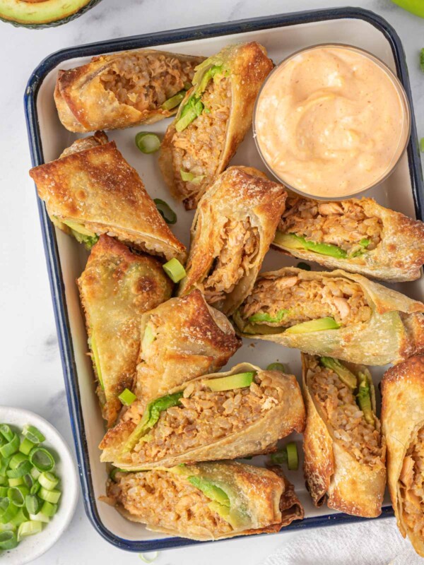 Seafood Egg Roll Recipe air fried and served cut in half on a tray with dipping sauce.