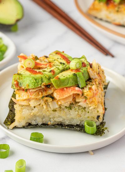 A piece of sushi bake on nori on a plate.