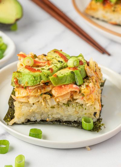 A piece of sushi bake on nori on a plate.