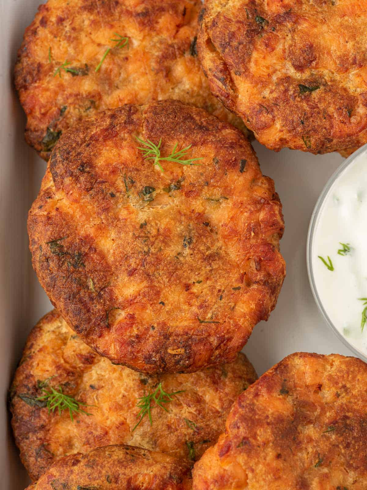 Closeup of air fryer salmon patties with bread crumbs.