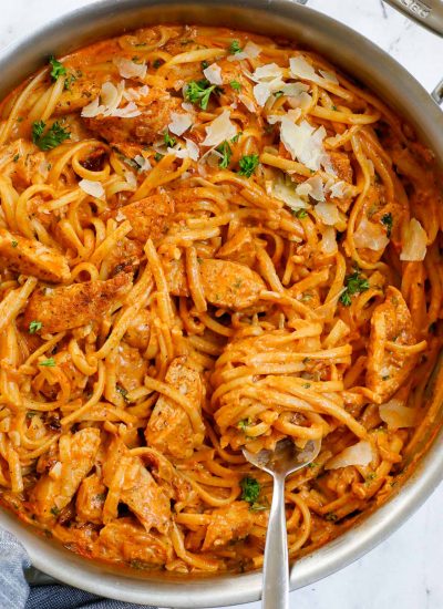 Creamy spicy chicken pasta in a skillet.