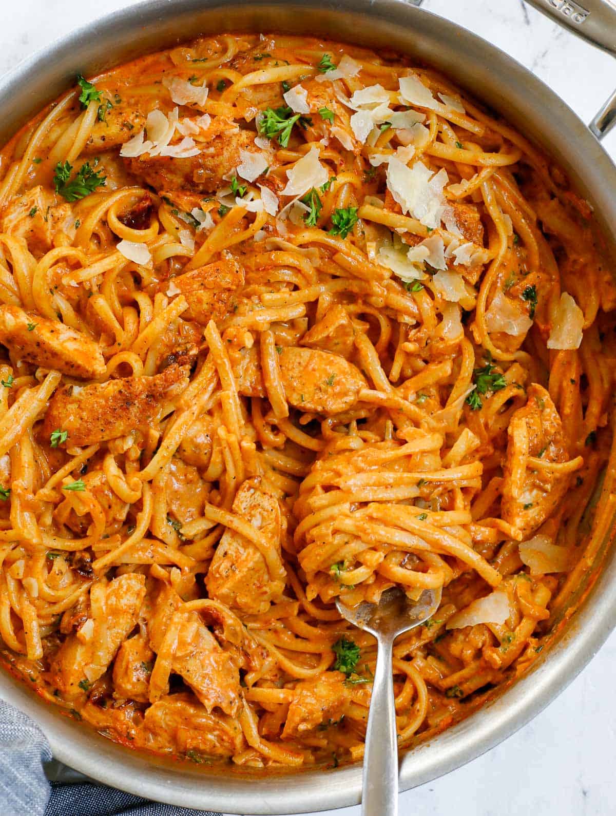 Creamy spicy chicken pasta in a skillet.