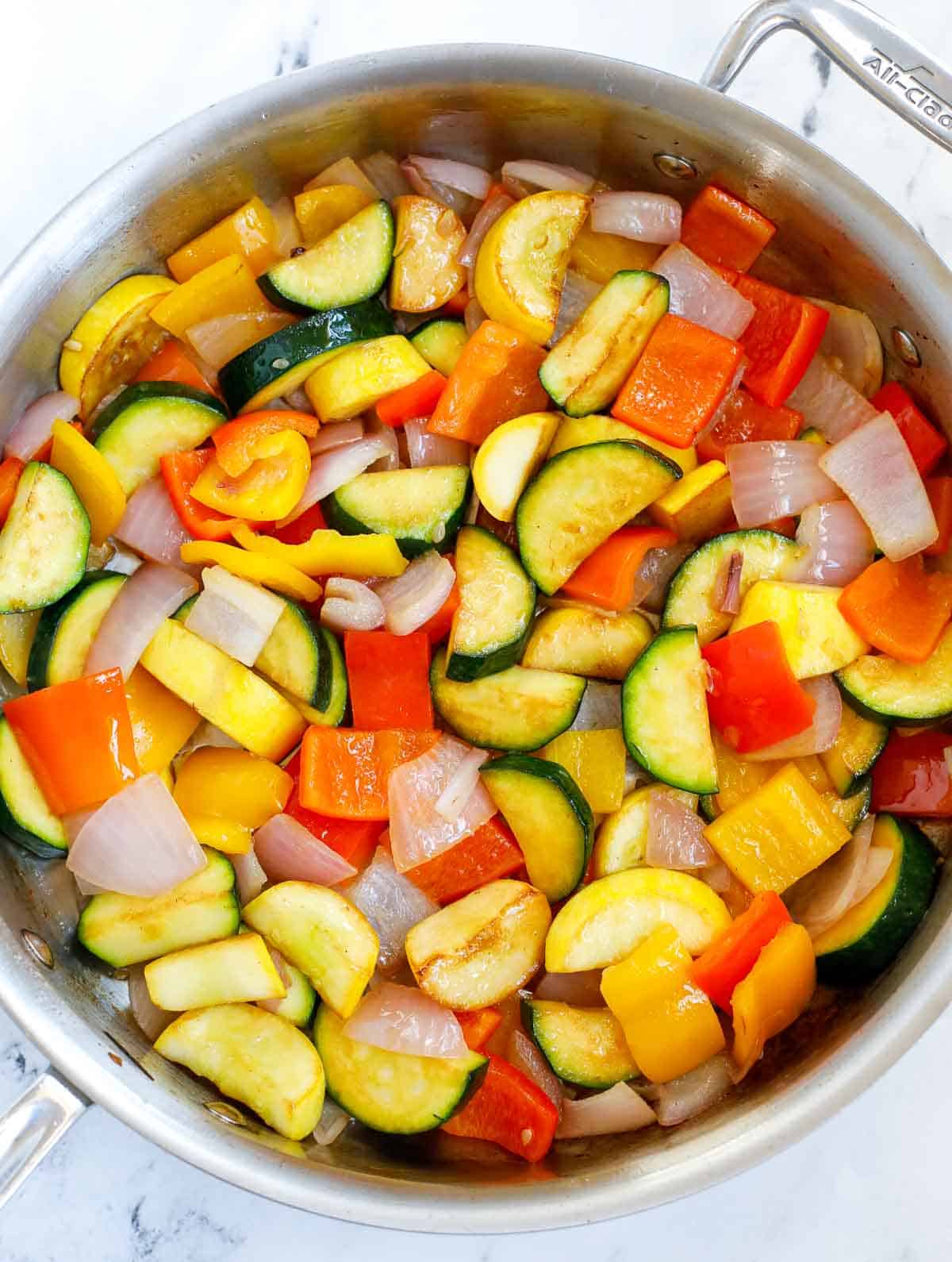 Saute vegetables for spicy chicken skillet.