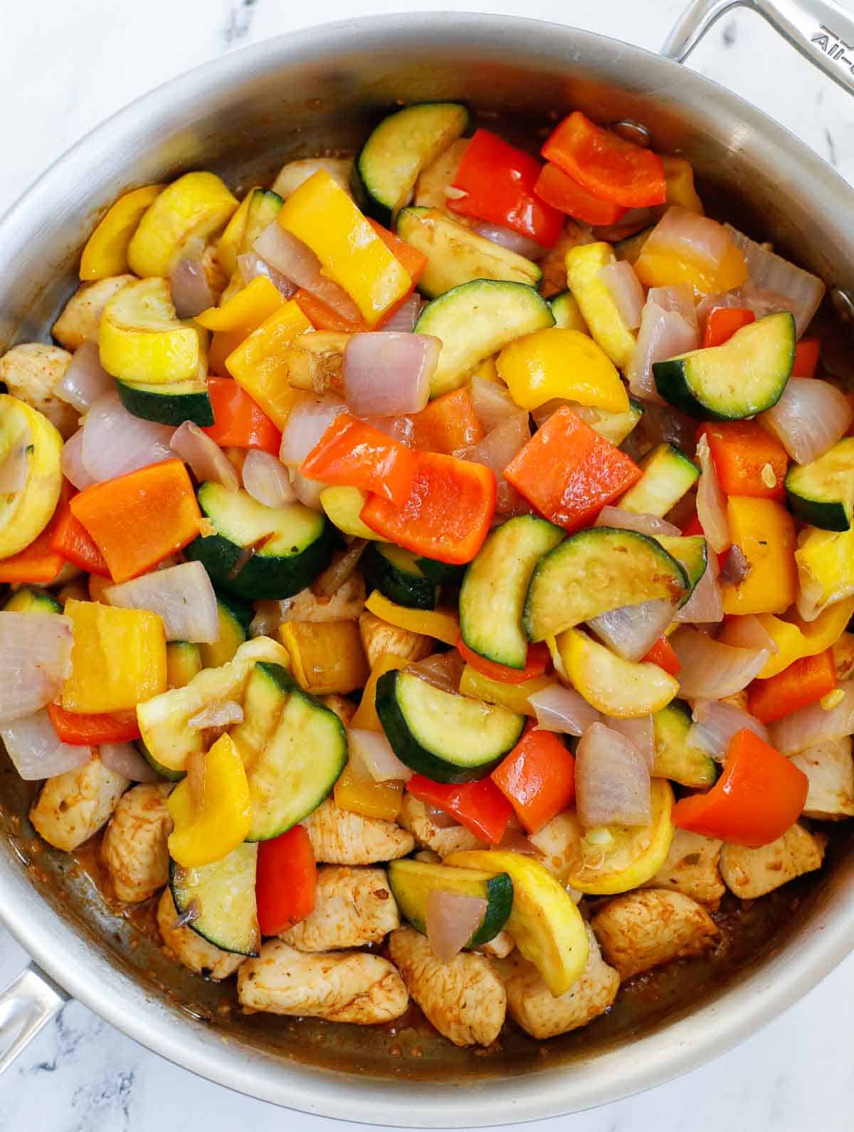 Combine chicken and veggie stir fry in a skillet.