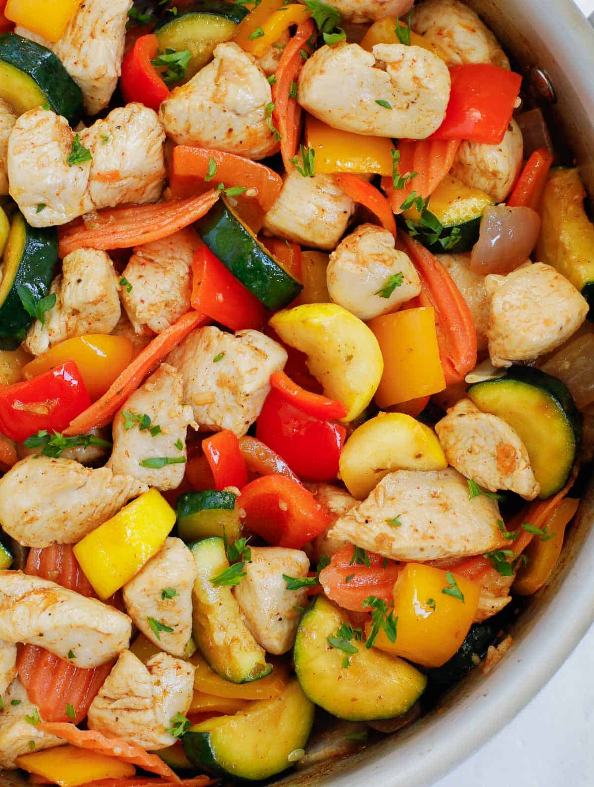 Closeup of one pan chicken and veggies.