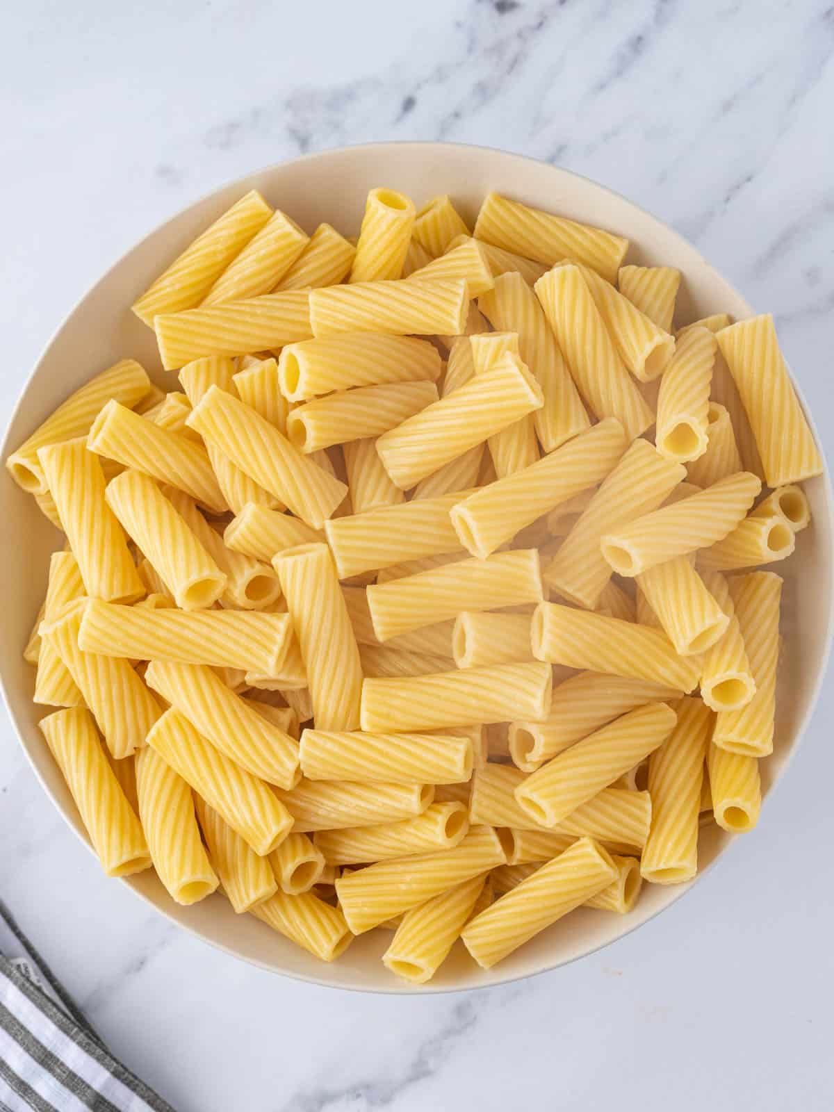 Cooked rigatoni pasta in a bowl.