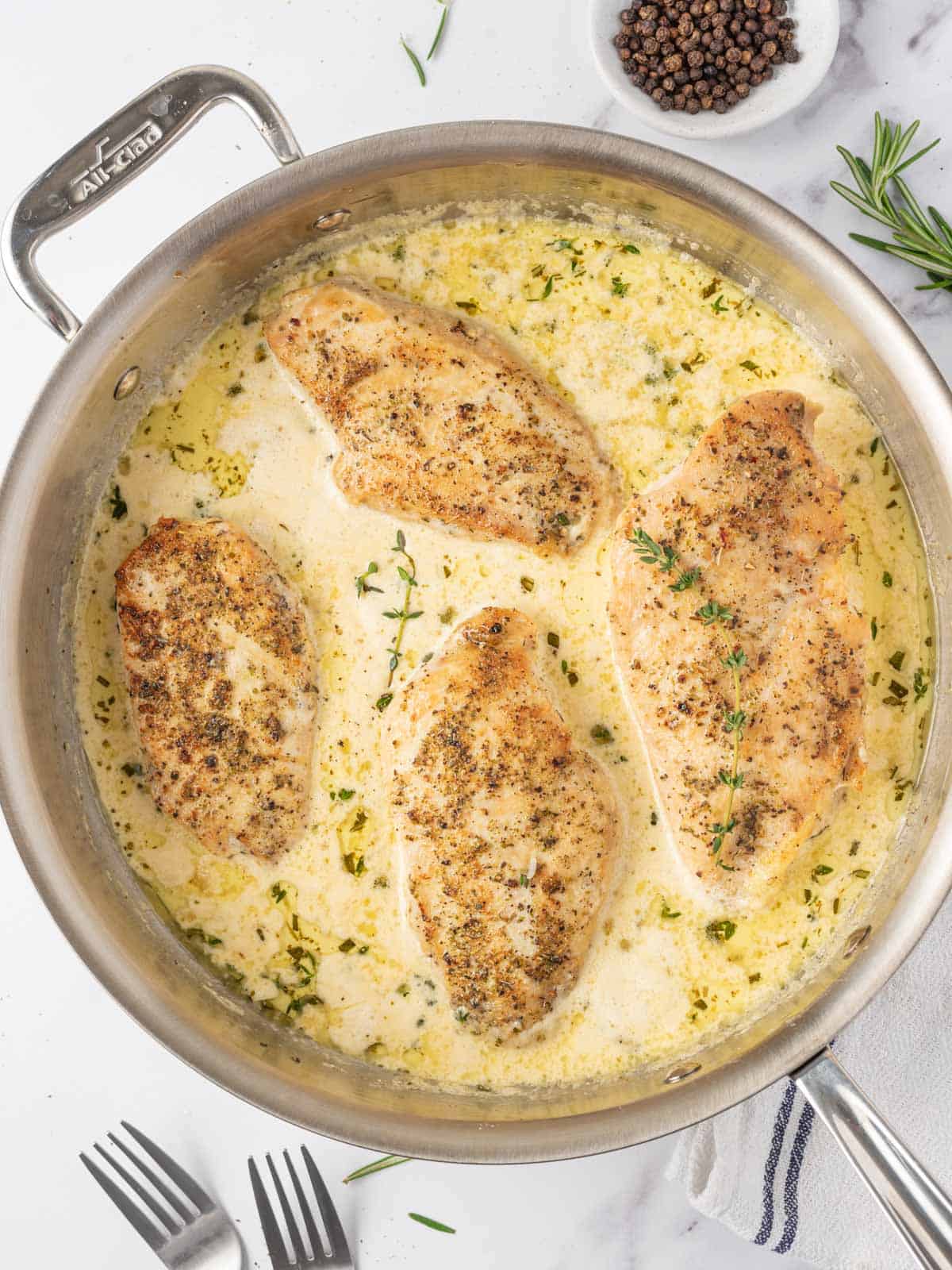 A skillet of creamy herbed chicken.