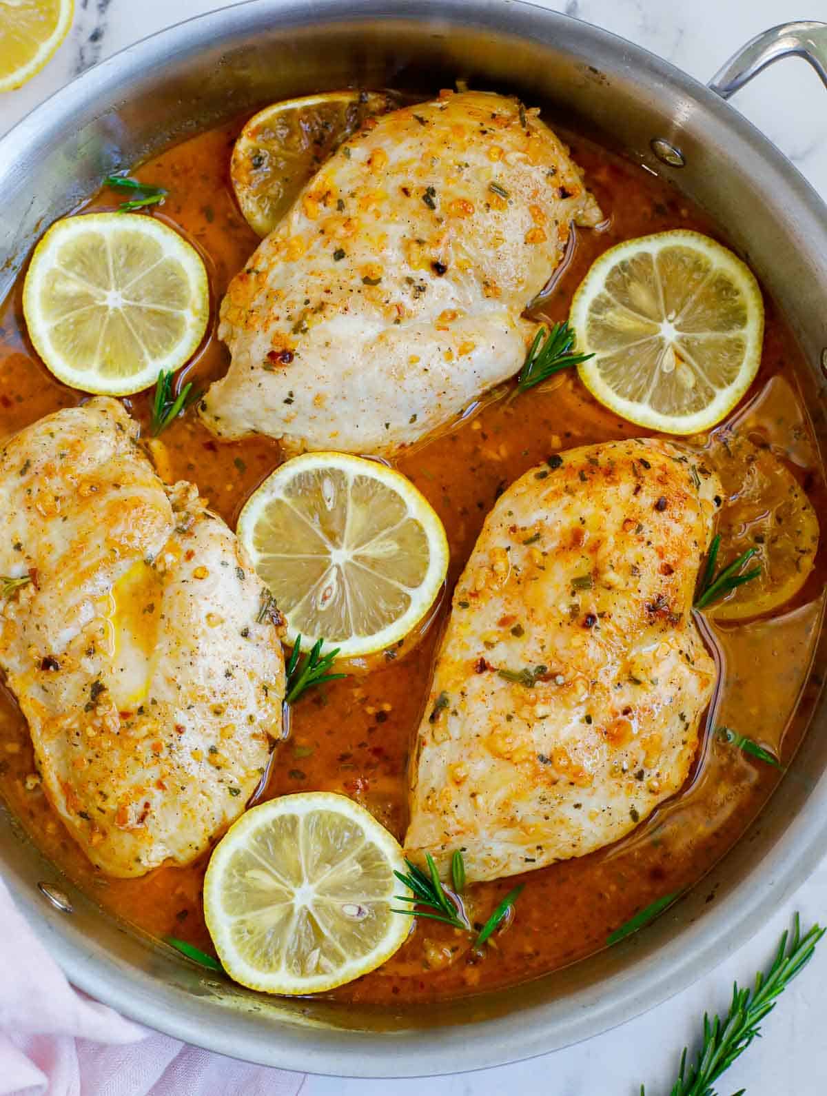 A skillet of baked rosemary chicken.