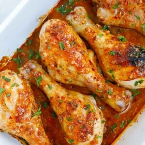 Chicken legs with honey mustard in a baking dish for serving.