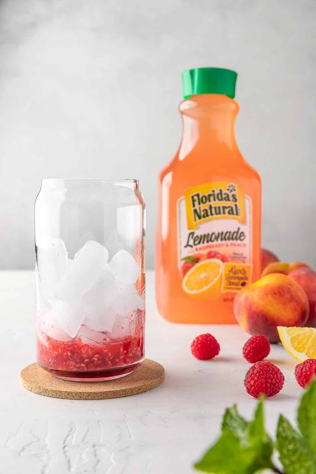 crushed raspberry in a cup filled with ice