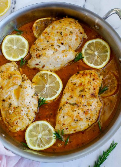 Rosemary lemon chicken breast in a skillet.