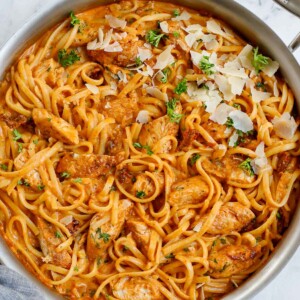 A skillet of chicken and spicy pasta sauce.