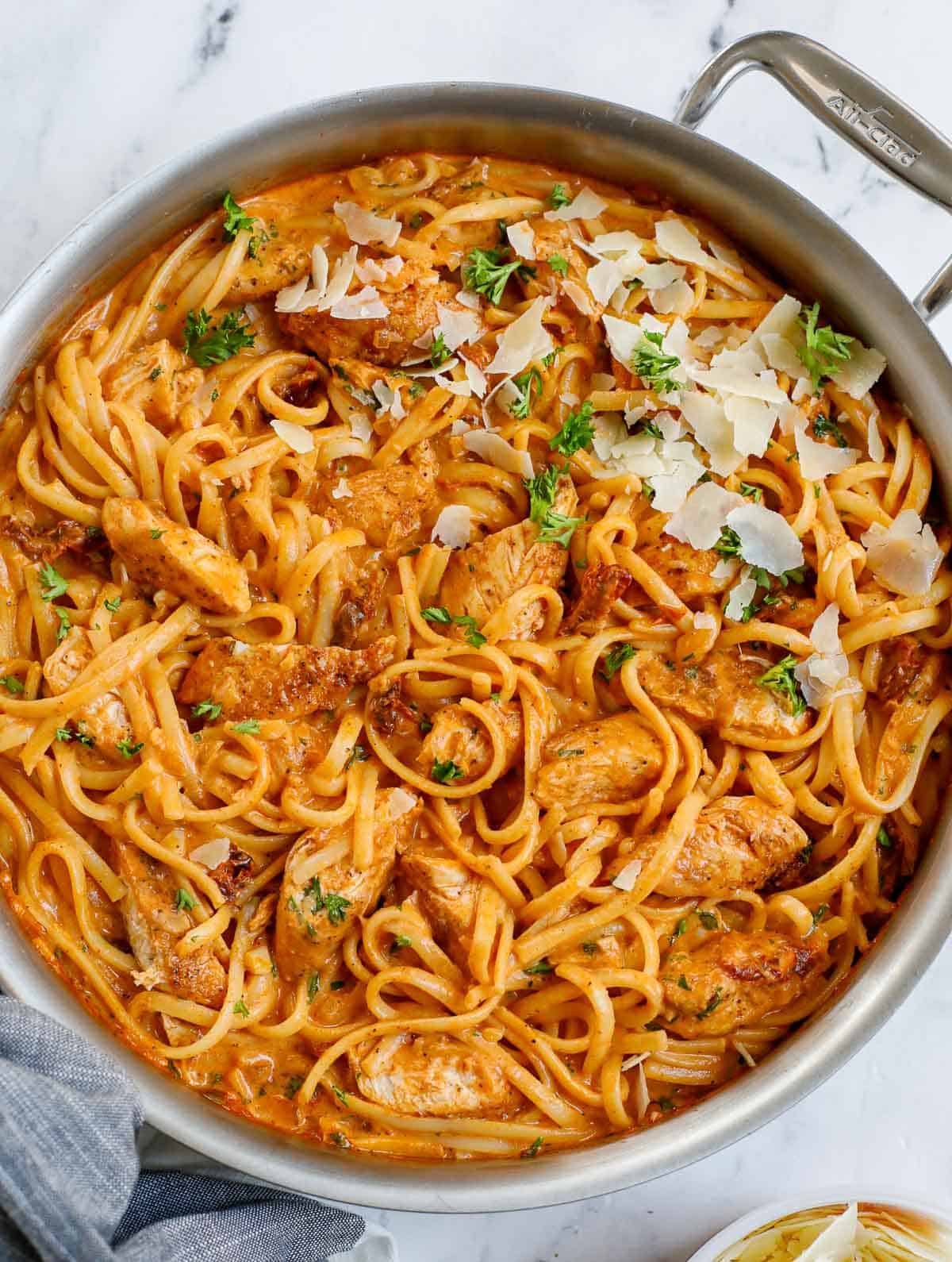 A skillet of chicken and spicy pasta sauce.