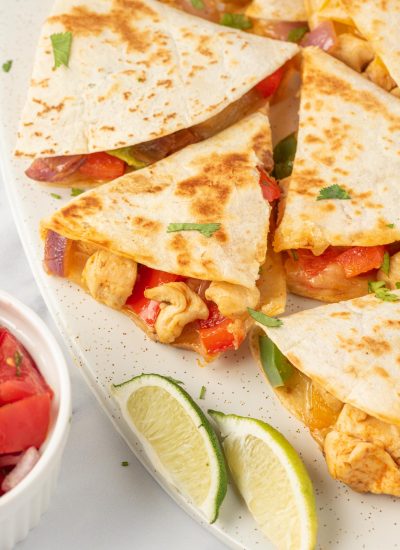 Fajita quesadillas cut into triangles and served on a plate.