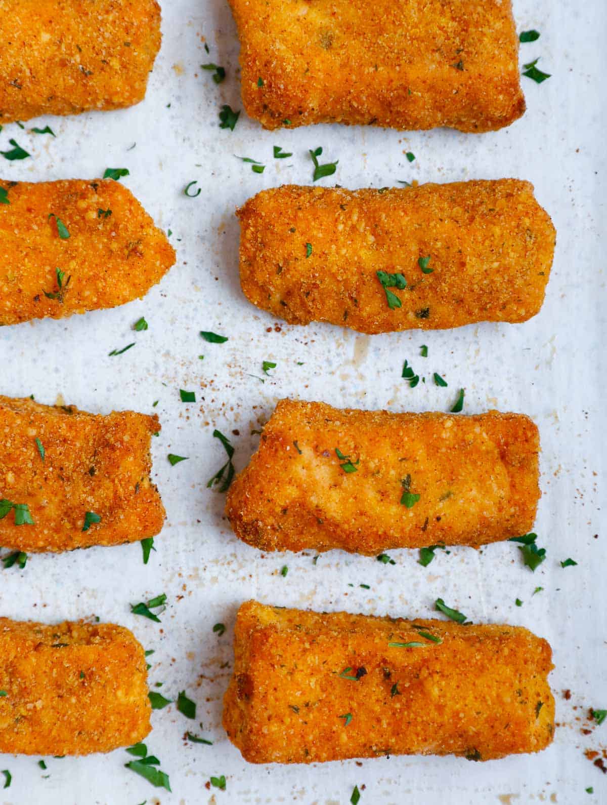 Salmon fish sticks on a baking tray.