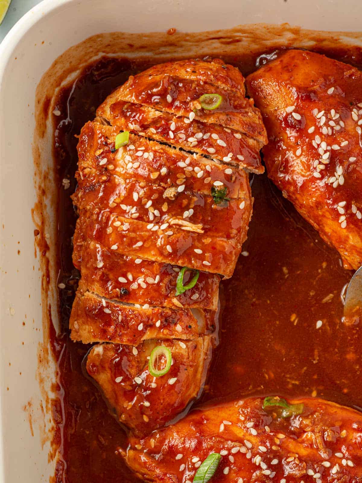 Spicy chicken breast recipe sliced in a pan for serving.