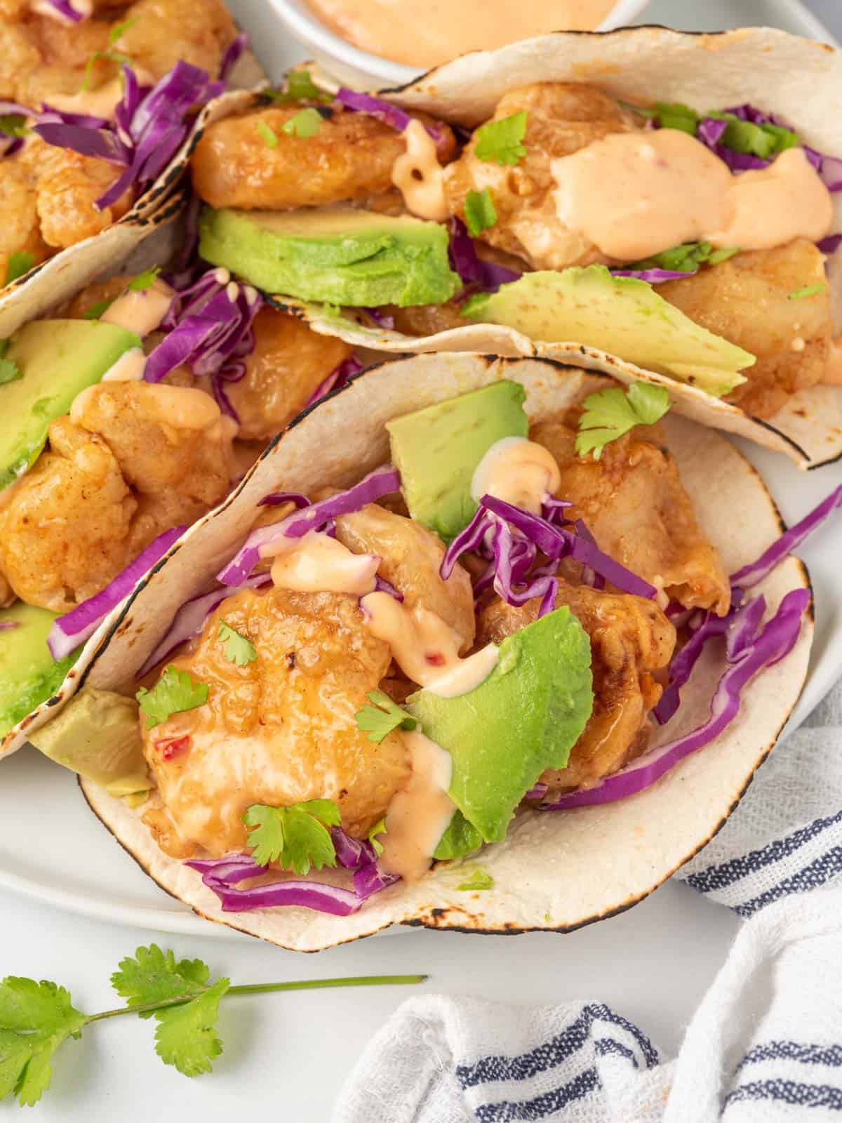 Close up of bang bang shrimp tacos.