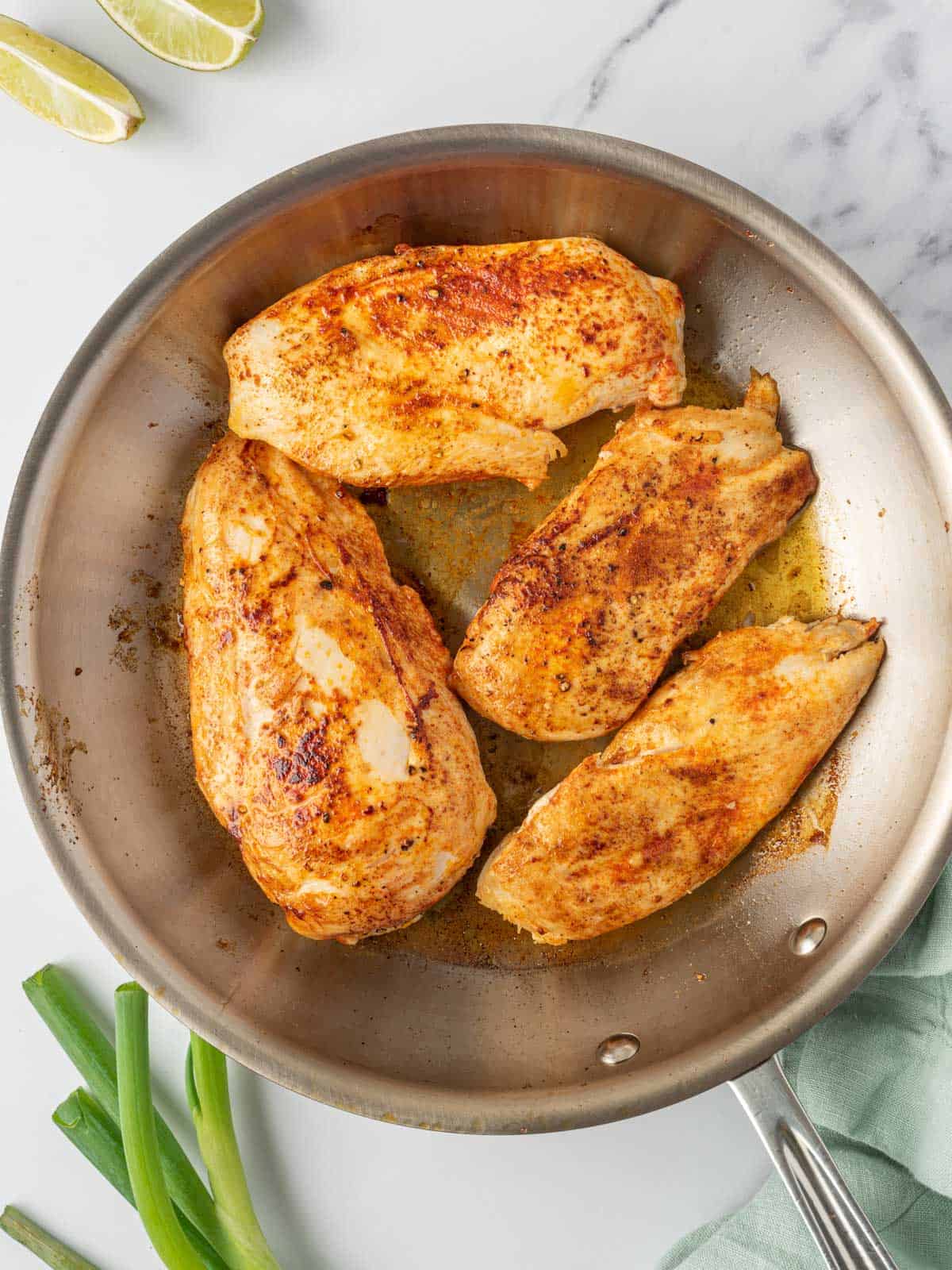Searing the spicy chicken breast recipe in a skillet.