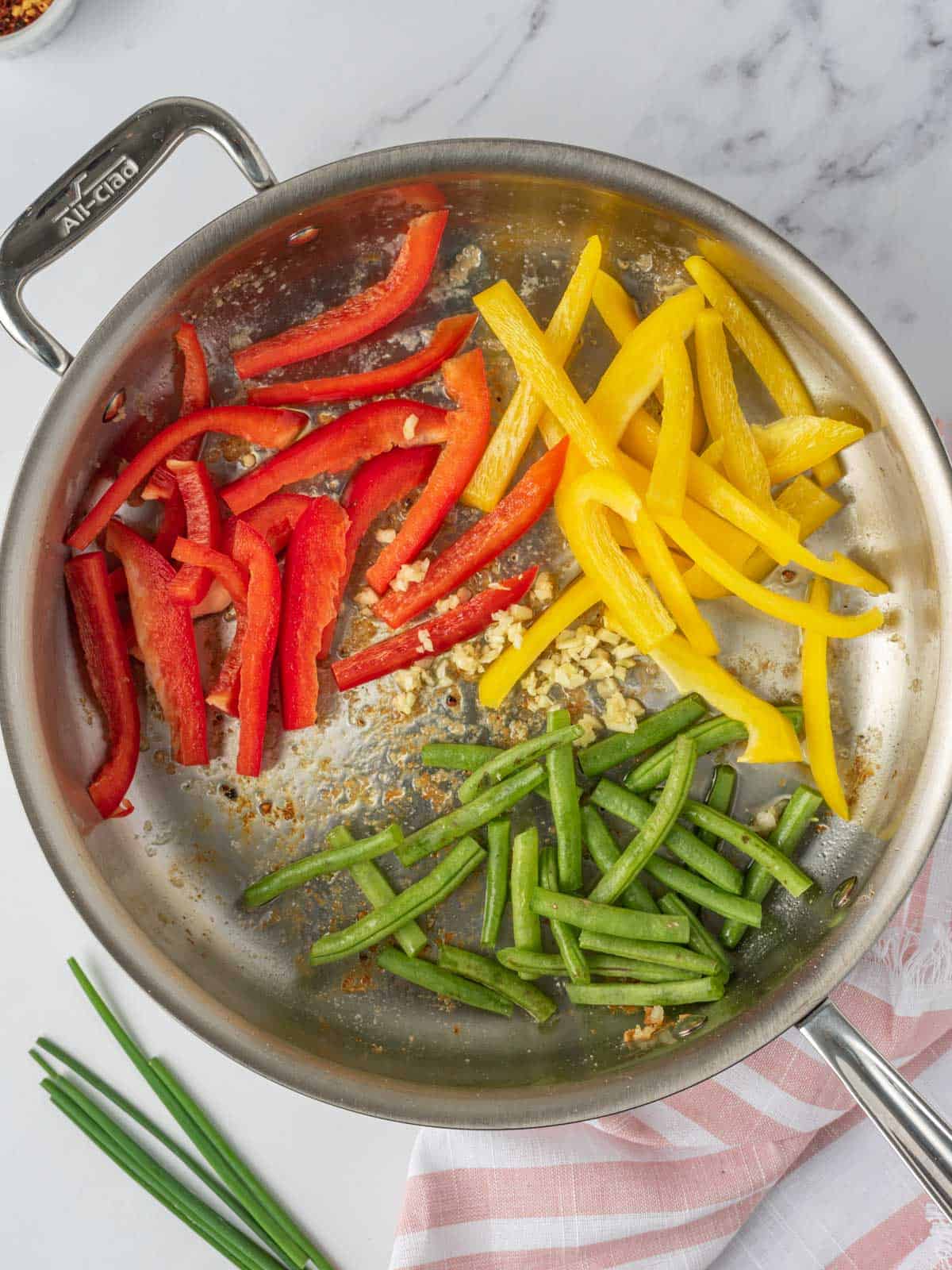 Stir fry veggies in a skillet.