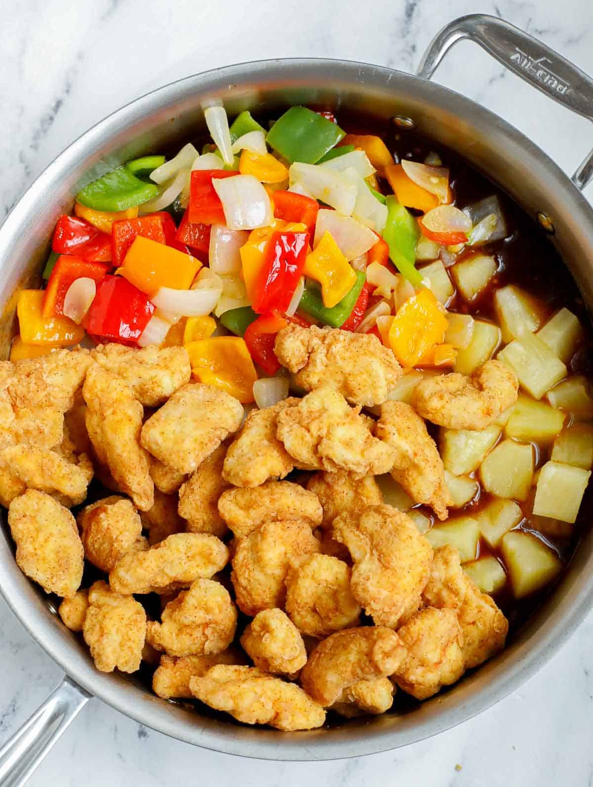 Combining ingredients for Chinese sweet and sour chicken recipe.
