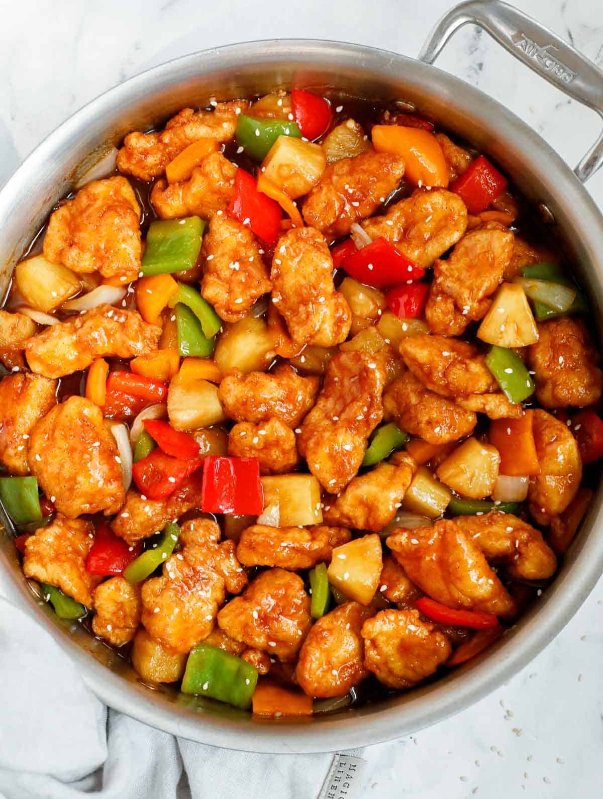 Homemade sweet and sour chicken in a skillet.