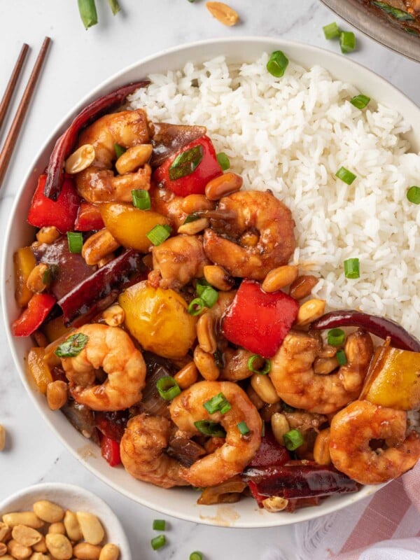 Spicy shrimp stir fry in a bowl with rice.