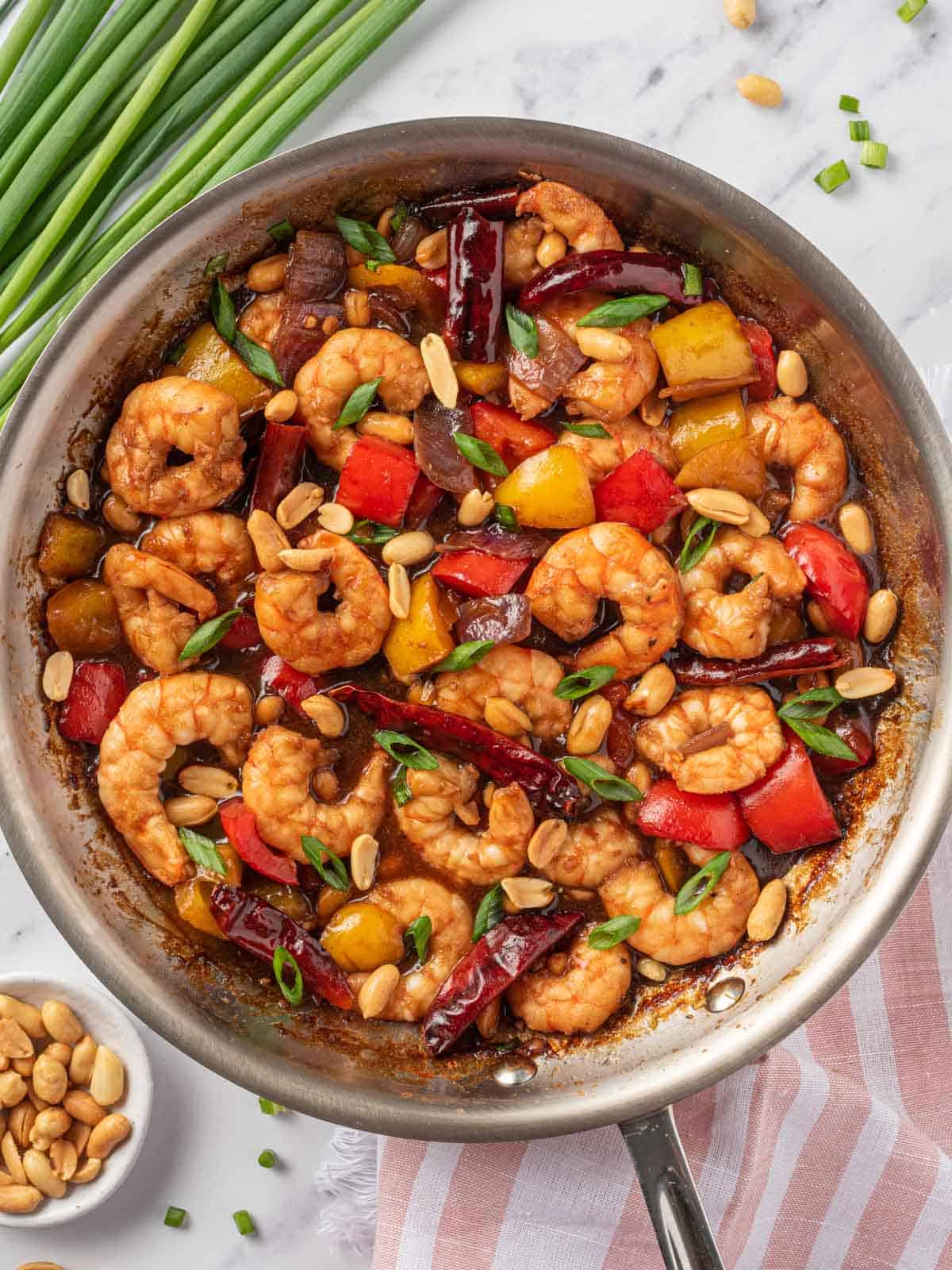 Kung pow shrimp in a skillet to be served.