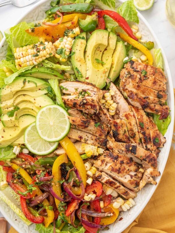 Fiesta lime chicken salad with lime garnish on a platter.