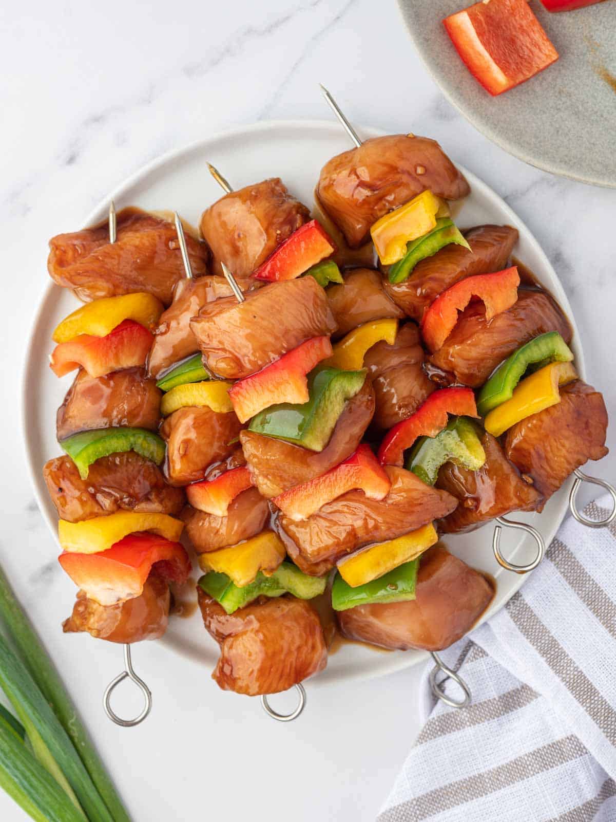 Marinated teriyaki chicken prepared for grilling.