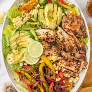 Southwest salad with grilled chicken on a serving platter.