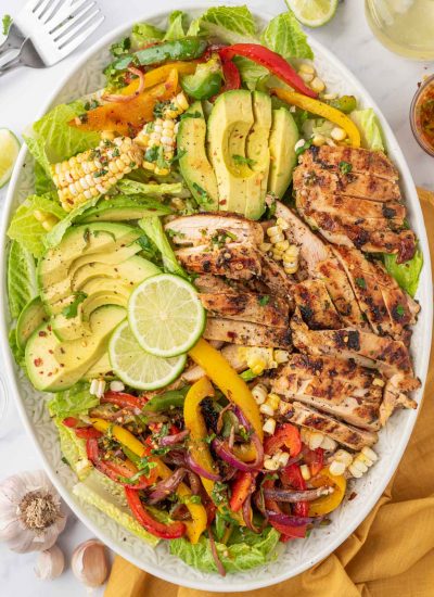 Southwest salad with grilled chicken on a serving platter.