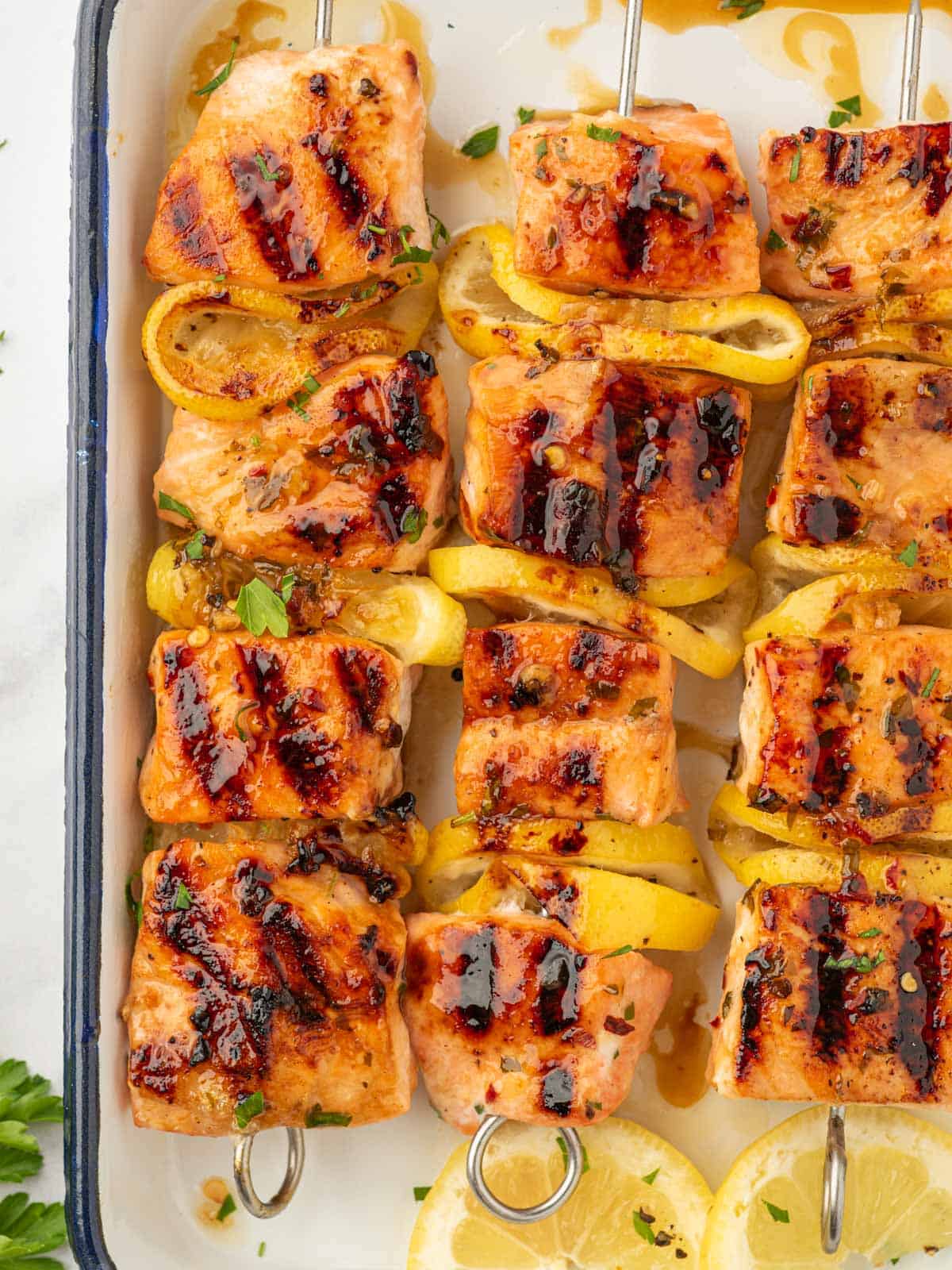 Salmon skewers on a platter.