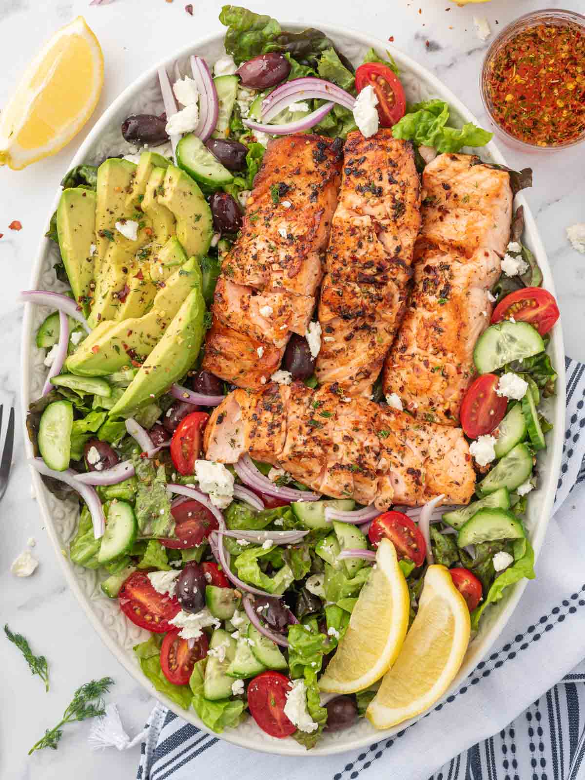Grilled salmon salad on a platter.