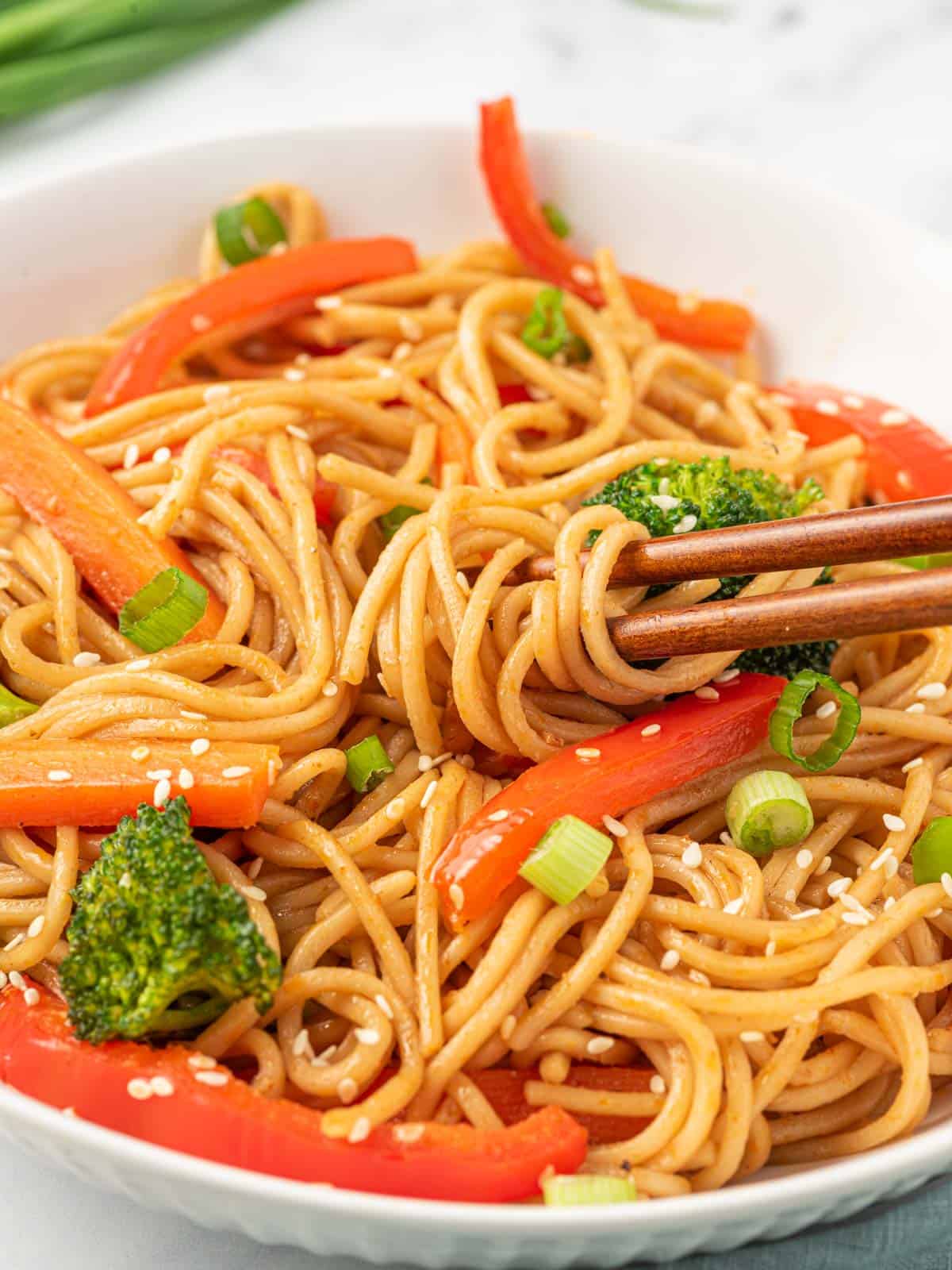 Vegetarian lo mein noodles in a bowl with chopsticks.