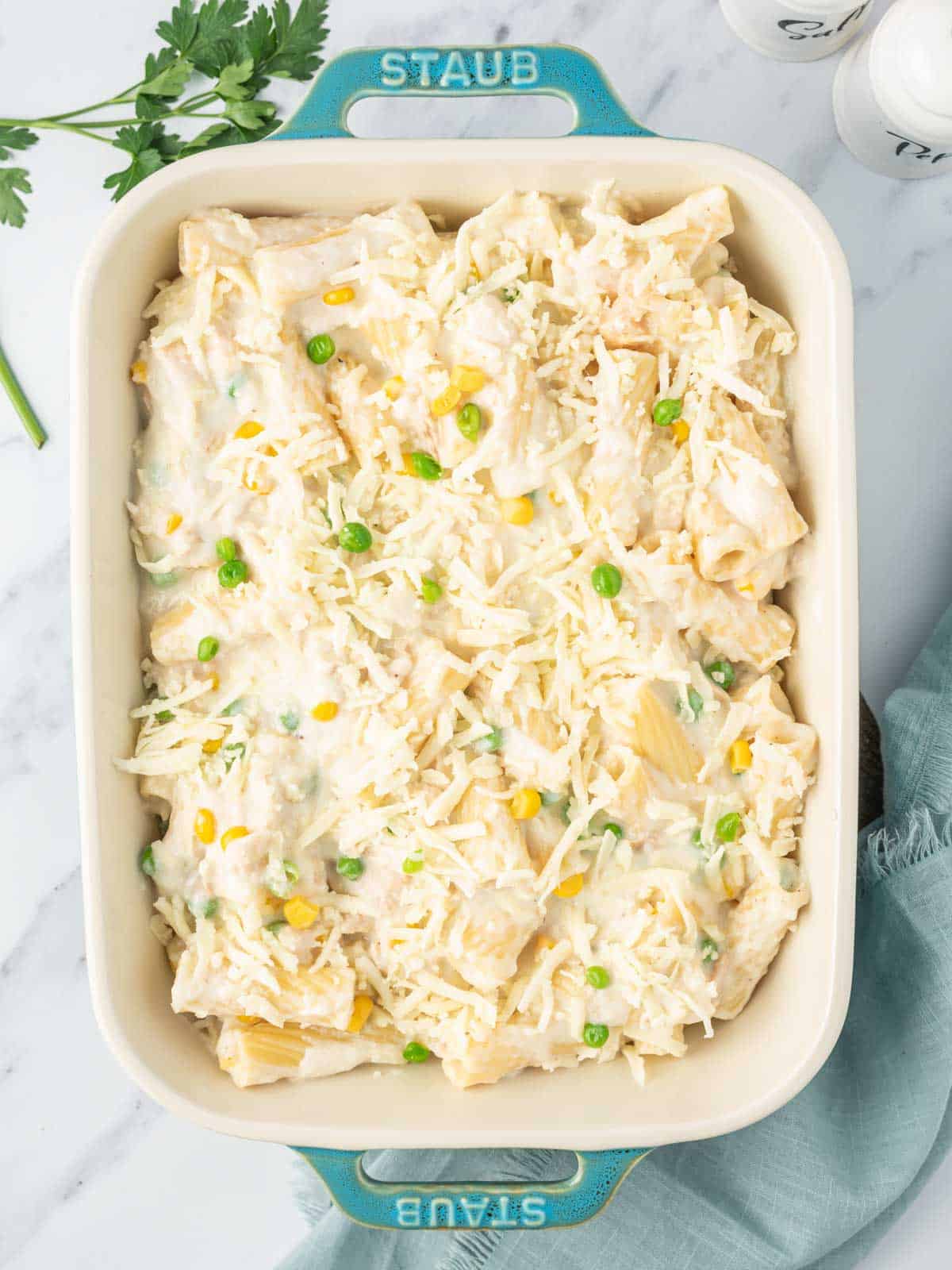 Tuna and noodles in a casserole dish ready to be baked.