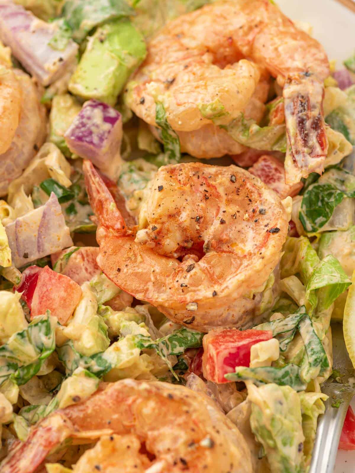 Closeup of shrimp salad with lettuce and avocado.