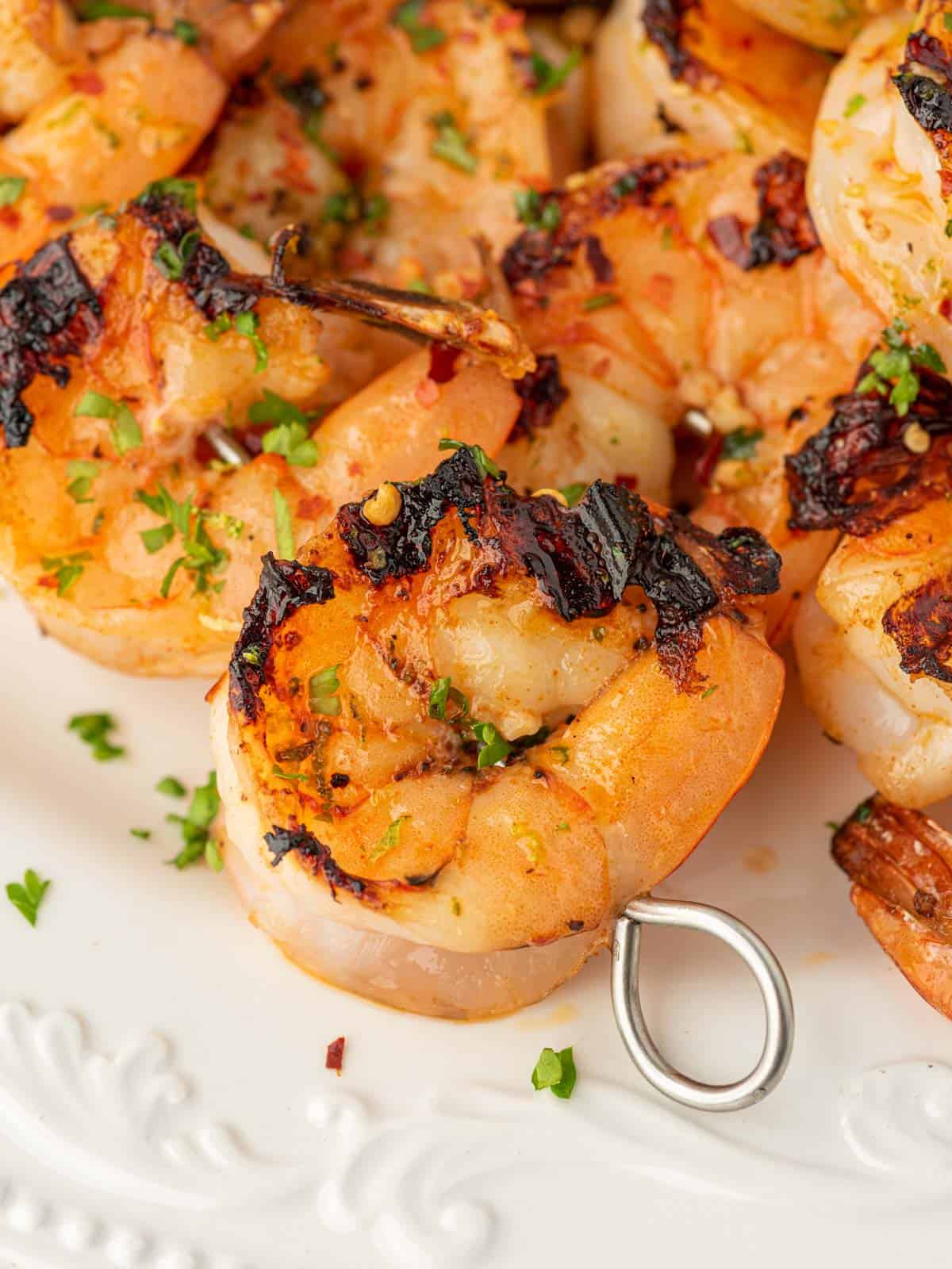 Closeup of zesty grilled garlic shrimp skewers.