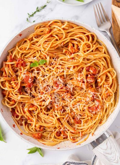 Ground chicken bolognese topped with parmesan cheese.