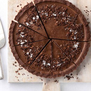 Sliced of vegan chocolate pie on a board.