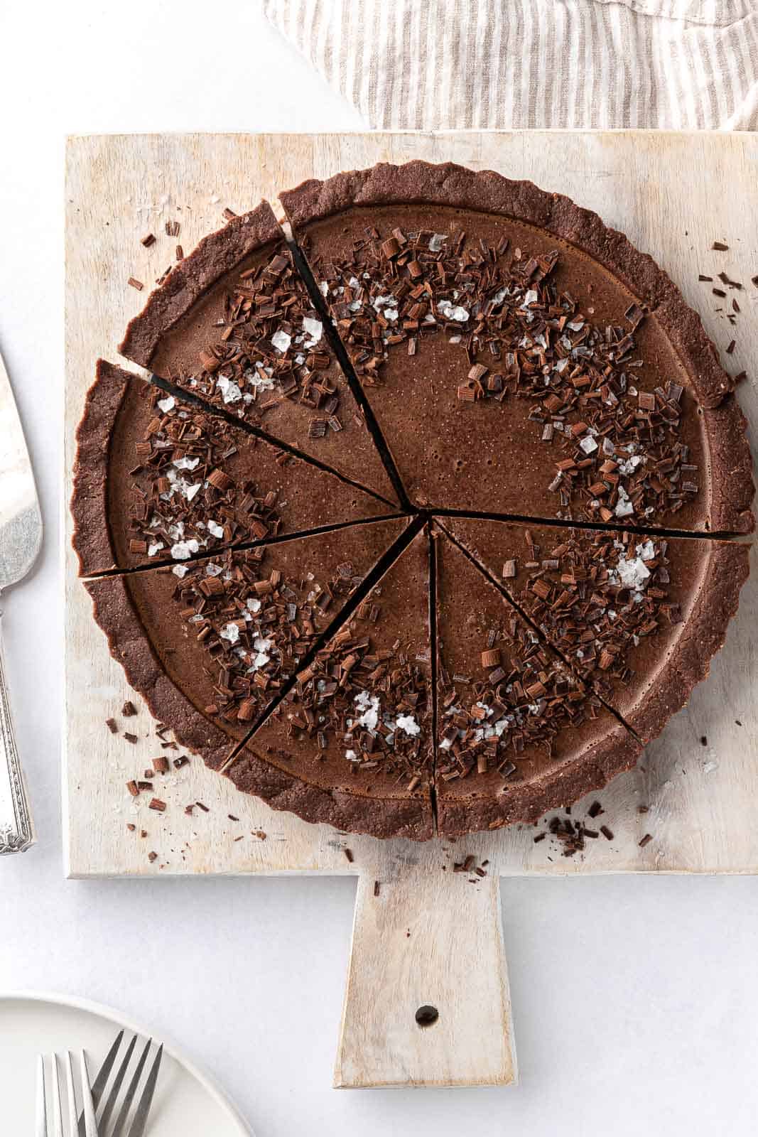 Sliced of vegan chocolate pie on a board.