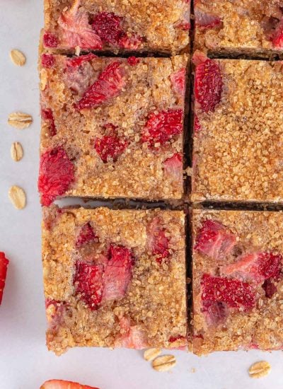 Closeup of oatmeal breakfast bars studded with strawberries.