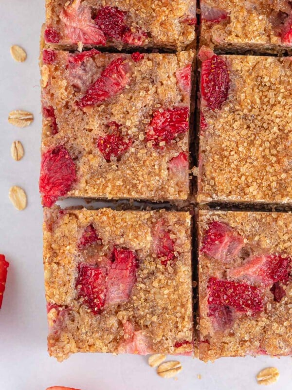 Closeup of oatmeal breakfast bars studded with strawberries.