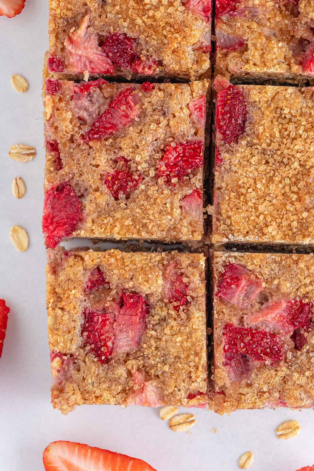 Closeup of oatmeal breakfast bars studded with strawberries.