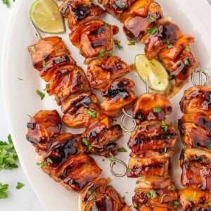 A platter of bbq chicken skewers ready for serving.