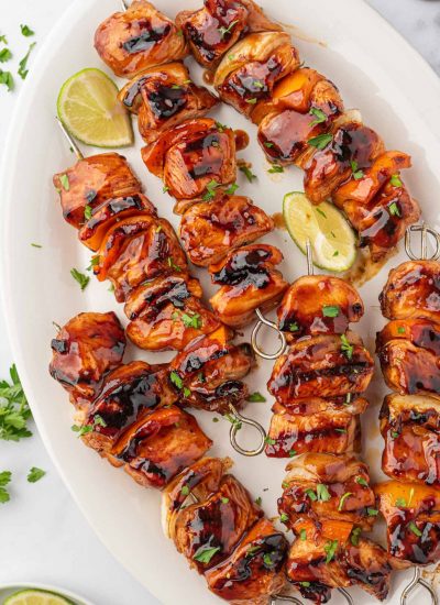 A platter of bbq chicken skewers ready for serving.