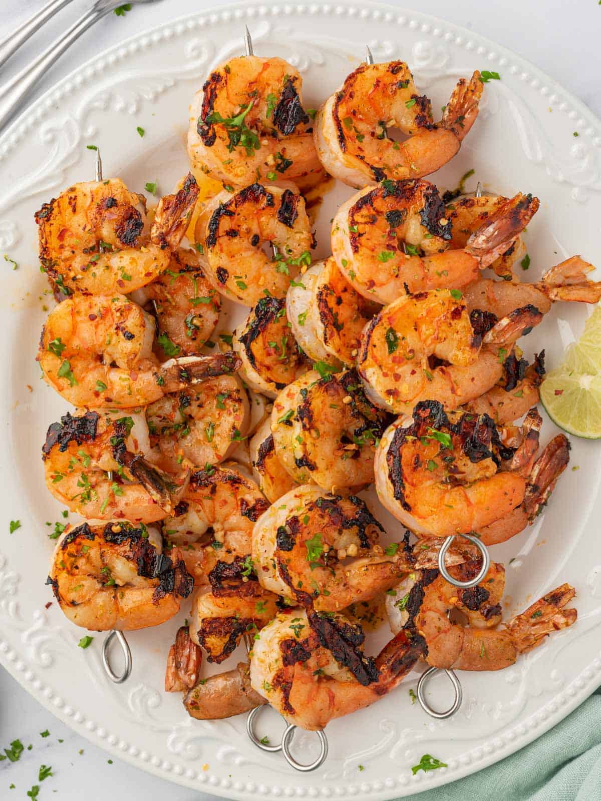 Zesty grilled garlic shrimp skewers on a platter.