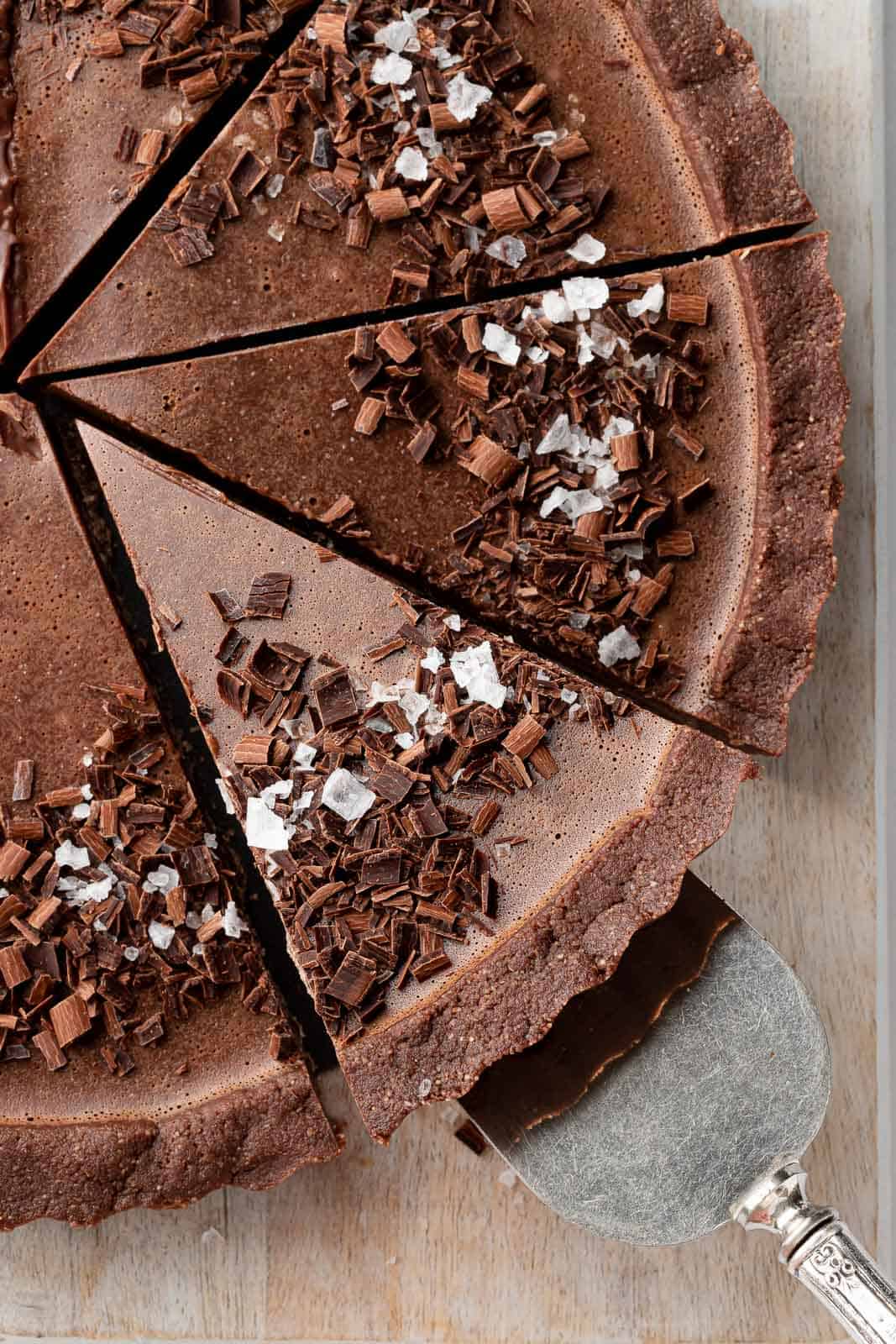 A slice of the best vegan pie is being lifted on a cake serving knife.