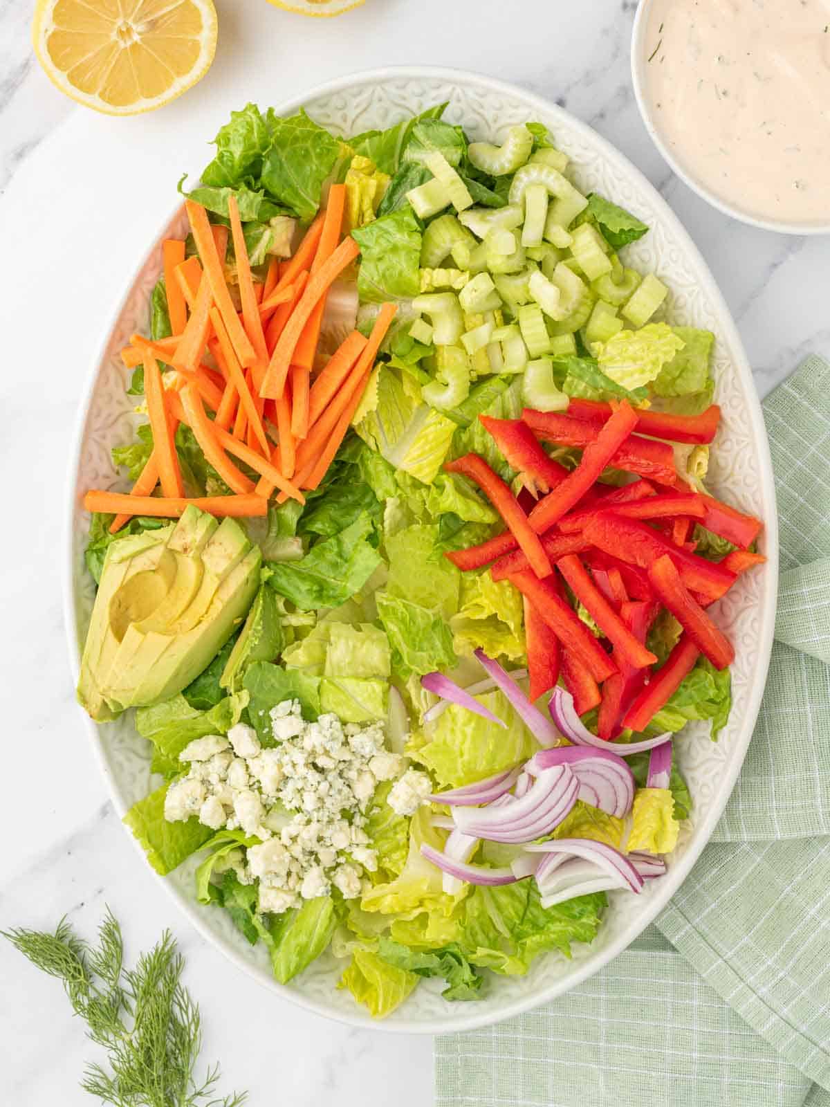 Process of building a buffalo chicken salad.