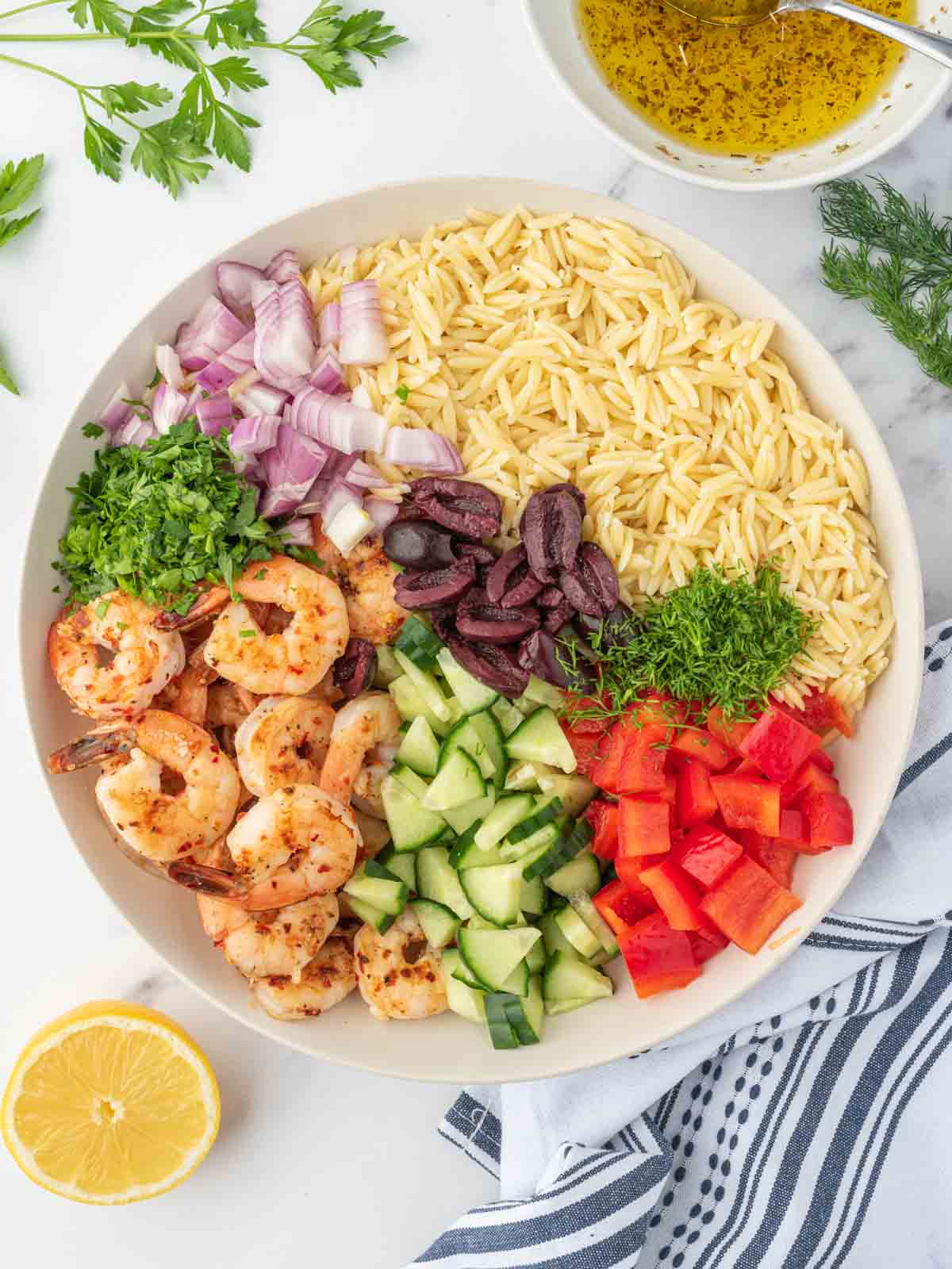 How to build an orzo salad with grilled shrimp in a bowl.